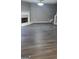 Open living room with hardwood floors, fireplace, and neutral gray walls at 9487 Lakeview Rd, Union City, GA 30291