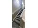 Carpeted staircase featuring a white handrail at 9487 Lakeview Rd, Union City, GA 30291