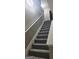 Carpeted staircase with white banister at 9487 Lakeview Rd, Union City, GA 30291