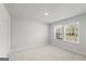 Neutral bedroom featuring two windows, carpeted floors, and light gray walls at 77 Werner Brook Way Sw, Atlanta, GA 30354