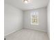 Bright bedroom features a window overlooking a green landscape and neutral colored carpet at 77 Werner Brook Way Sw, Atlanta, GA 30354