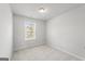 Bright bedroom features a window overlooking a green landscape and neutral colored carpet at 77 Werner Brook Way Sw, Atlanta, GA 30354