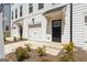 Close up of a new townhome exterior featuring a single car garage and black front door at 77 Werner Brook Way Sw, Atlanta, GA 30354