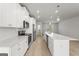 Modern kitchen featuring white cabinets, stainless steel appliances, subway tile backsplash, and a large island at 77 Werner Brook Way Sw, Atlanta, GA 30354