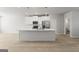 Bright kitchen with white cabinets, stainless appliances, an island with a sink and pendant lighting at 77 Werner Brook Way Sw, Atlanta, GA 30354
