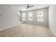 Spacious living room with three large windows offering plenty of natural light, and adjacent stairway at 77 Werner Brook Way Sw, Atlanta, GA 30354
