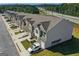Aerial view of townhome complex, showcasing landscaping, parking, and architectural design at 8654 Lakeview Commons # 38, Jonesboro, GA 30238