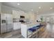 Modern kitchen boasts granite countertops, island with seating, stainless appliances, and open living area at 8654 Lakeview Commons # 38, Jonesboro, GA 30238