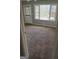 Large bedroom with carpet flooring, a large window and a neutral paint scheme at 6006 Blackhawk Se Trl, Mableton, GA 30126