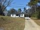 Charming one-story home with a white exterior and a long driveway at 6006 Blackhawk Se Trl, Mableton, GA 30126