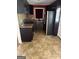 Cozy kitchen featuring tile backsplash, dark cabinets and matching appliances at 6006 Blackhawk Se Trl, Mableton, GA 30126