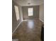 Neutral living room with great natural light, tile flooring, and neutral walls at 6006 Blackhawk Se Trl, Mableton, GA 30126
