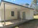 Covered patio with gray door, light siding and concrete flooring at 6006 Blackhawk Se Trl, Mableton, GA 30126