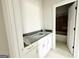New bathroom vanity featuring gray countertop, white cabinetry, and modern gold hardware at 138 Silvercrest Dr # 169, Acworth, GA 30101