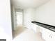 Bathroom area featuring white cabinetry, black countertops, and white trim at 138 Silvercrest Dr # 169, Acworth, GA 30101