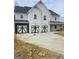 Charming two-story home boasts a three-car garage with modern black and white doors at 138 Silvercrest Dr # 169, Acworth, GA 30101