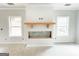 Living room fireplace with shiplap detailing, wooden mantel, and windows providing outdoor views at 138 Silvercrest Dr # 169, Acworth, GA 30101