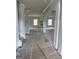 Hallway with white trim and light gray walls leading to another room with windows and fireplace at 138 Silvercrest Dr # 169, Acworth, GA 30101