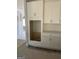 Detailed view of the kitchen featuring a built-in microwave cabinet and white cabinets at 138 Silvercrest Dr # 169, Acworth, GA 30101