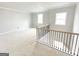 Living room with neutral paint, windows, and rail overlooking the stairwell at 138 Silvercrest Dr # 169, Acworth, GA 30101