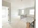 Living room with neutral paint, windows, and rail overlooking the stairwell at 138 Silvercrest Dr # 169, Acworth, GA 30101