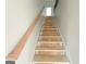 New staircase with unfinished wood handrail leading to the upper level at 138 Silvercrest Dr # 169, Acworth, GA 30101