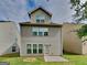 Back exterior featuring a backyard, vinyl siding, multiple windows, and a back door at 3741 Upland Dr, Mcdonough, GA 30253