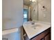 Bathroom featuring a white countertop sink, framed mirror, and a view of the bedroom at 3741 Upland Dr, Mcdonough, GA 30253