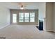 Bright living room featuring plush carpeting, fireplace, and multiple windows, creating a cozy and inviting space at 3741 Upland Dr, Mcdonough, GA 30253