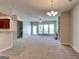 Open-concept living room featuring neutral walls and carpet, seamlessly connecting to the kitchen at 3741 Upland Dr, Mcdonough, GA 30253