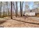 A well-sized backyard featuring mature trees that offers plenty of room for outdoor activities and relaxation at 104 Pine Pt, Peachtree City, GA 30269
