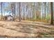 Expansive backyard featuring mature trees, a swing set, and ample space for outdoor activities at 104 Pine Pt, Peachtree City, GA 30269