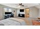 Comfortable bedroom showcasing a ceiling fan, dual monitors, TV, and natural lighting at 104 Pine Pt, Peachtree City, GA 30269