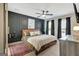 Stunning bedroom with dark accent wall, ceiling fan, hardwood flooring, and natural light at 104 Pine Pt, Peachtree City, GA 30269