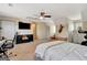 Bedroom with ceiling fan, a TV, and a workspace; carpeted floors and soft lighting at 104 Pine Pt, Peachtree City, GA 30269