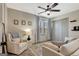 Cozy bedroom featuring a ceiling fan, closet, window, and neutral color scheme at 104 Pine Pt, Peachtree City, GA 30269