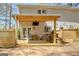 Backyard deck with outdoor kitchen, dining area and outdoor lighting for evening relaxation and entertainment at 104 Pine Pt, Peachtree City, GA 30269