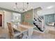 Inviting dining room with a chandelier, stairs to the left, and an open floor plan at 104 Pine Pt, Peachtree City, GA 30269
