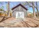 A detached garage features an overhead door, a modern style, and gravel landscape at 104 Pine Pt, Peachtree City, GA 30269