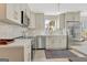Well-lit kitchen features stainless steel appliances, sleek countertops, and a mosaic tile backsplash at 104 Pine Pt, Peachtree City, GA 30269