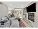 Spacious living room featuring a fireplace, comfortable seating, and access to the outdoors for a seamless indoor-outdoor experience at 104 Pine Pt, Peachtree City, GA 30269