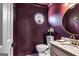Stylish powder room featuring dark walls, unique decor, and a decorative mirror at 104 Pine Pt, Peachtree City, GA 30269
