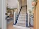 Carpeted staircase leading to the second floor, with views of the dining and living areas at 104 Pine Pt, Peachtree City, GA 30269