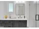 Clean bathroom featuring a shower with a glass door and dark gray cabinets at 265 High St, Fayetteville, GA 30214