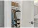 Small closet with shelving, hanging clothes, and storage, plus a glimpse of a bathroom vanity at 265 High St, Fayetteville, GA 30214