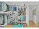 Organized walk-in closet featuring custom shelving, rods, and storage for clothes, shoes, bags, and plants at 265 High St, Fayetteville, GA 30214