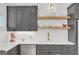 Well-appointed kitchen features gray cabinetry, open shelving, and stainless steel appliances at 265 High St, Fayetteville, GA 30214