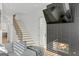 Stylish living room features a modern fireplace, a comfortable sofa, and a staircase at 265 High St, Fayetteville, GA 30214