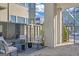 Inviting patio area with cushioned chairs, accent table, and view to the community walkway at 265 High St, Fayetteville, GA 30214