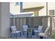 Cozy outdoor patio with comfortable seating around a small table and a decorative black panel at 265 High St, Fayetteville, GA 30214